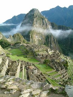 Sunrise over Huayna Picchu towering above the ruins of Machu Picchu